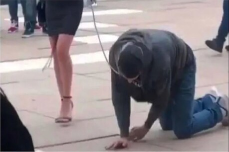 স্বামীৰ ডিঙিত কুকুৰৰ শিকলি বান্ধি ৰাজপথত ঘূৰালে পত্নীয়ে, দৃশ্য ভাইৰেল