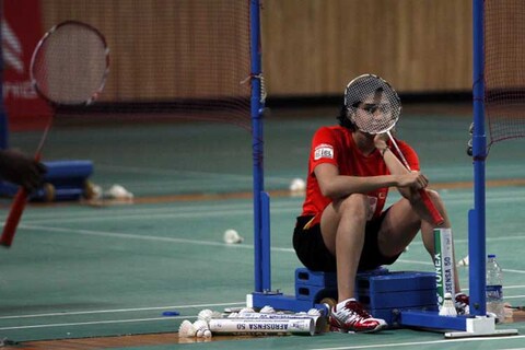PUNE, INDIA - AUGUST 21: Pune Pistons player Ashwini Ponappa watches as her teammates practice for the Indian Badminton League matches to be held at Shri Shiv Chhatrapati Shivaji stadium on August 21, 2013 in Pune, India. (Photo by Santosh Harhare/Hindustan Times via Getty Images)