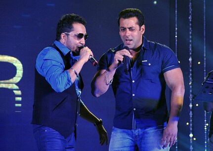 Indian Bollywood play back singer Mika Singh (L) and actor and producer Salman Khan perform during the Eid special song launch of the upcoming Hindi film 'Bajrangi Bhaijaan' directed by Kabir Khan in Mumbai on July 3, 2015. AFP PHOTO (Photo credit should read STR/AFP/Getty Images)