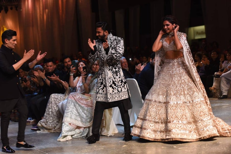   Ranveer Singh was seen in these pictures in a white embroidered black sherwani and pyjama while his wife and actress Deepika Padukone looked stunning in a white and golden colored lehenga.  (Photo Credits: Viral Bhayani)