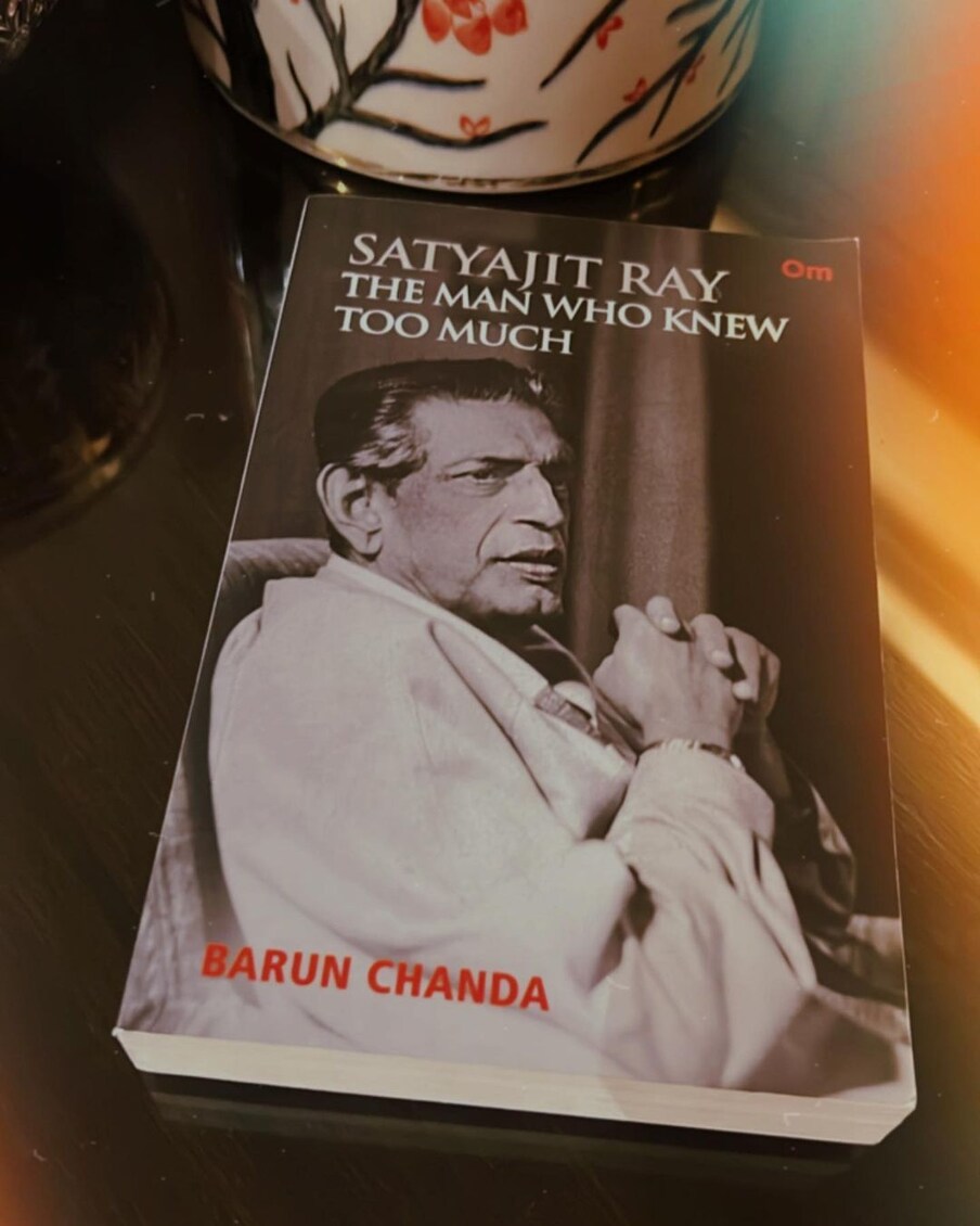  करिश्मा कपूर घर में चिल करते हुए पढ़ रही हैं. इस तस्वीर में उन्हें बरुण चंदा की किताब 'सत्यजीत रे - द मैन हू नो टू मच बाय' पढ़ रही हैं. (फोटो साभारः Instagram @therealkarismakapoor)