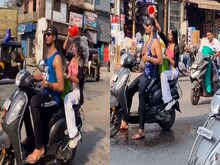 VIDEO: बीच सड़क चलती स्कूटी पर नहाना लड़का-लड़की को पड़ा भारी, अब हो गया एक्शन