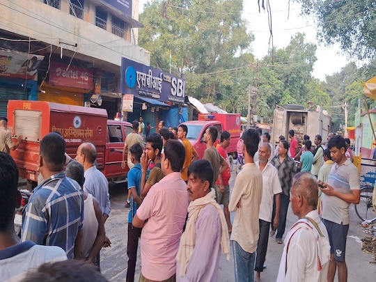 आग लगने के बाद काबू पाने की कोशिश करते दमकलकर्मी व मौके पर मौजूद लोग.