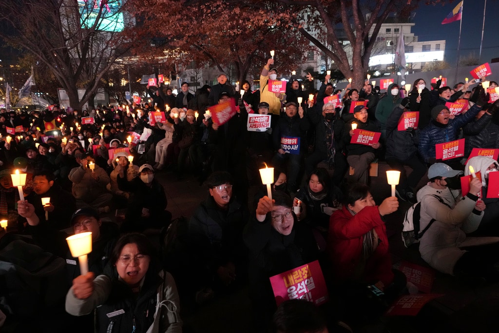 People hold a candle-lit vigil against South Korean President Yoon Suk Yeol in Seoul, South Korea, Wednesday, Dec. 4, 2024. (AP Photo/Lee ​​Jin-man)