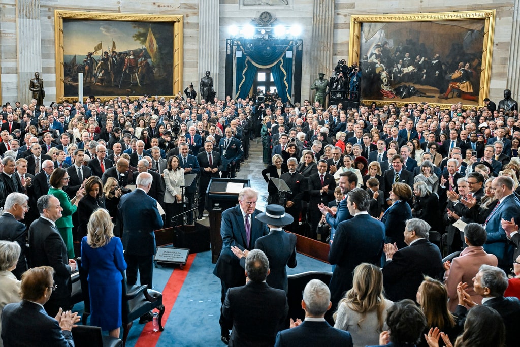 President Donald Trump speaks with First Lady Melania Trump as he departs after speaking after taking the oath of office at the 60th Presidential Inauguration in the Rotunda of the U.S. Capitol in Washington, Monday, Jan. 20, 2025. (Kenny Holston/The New York Times via AP, Pool)