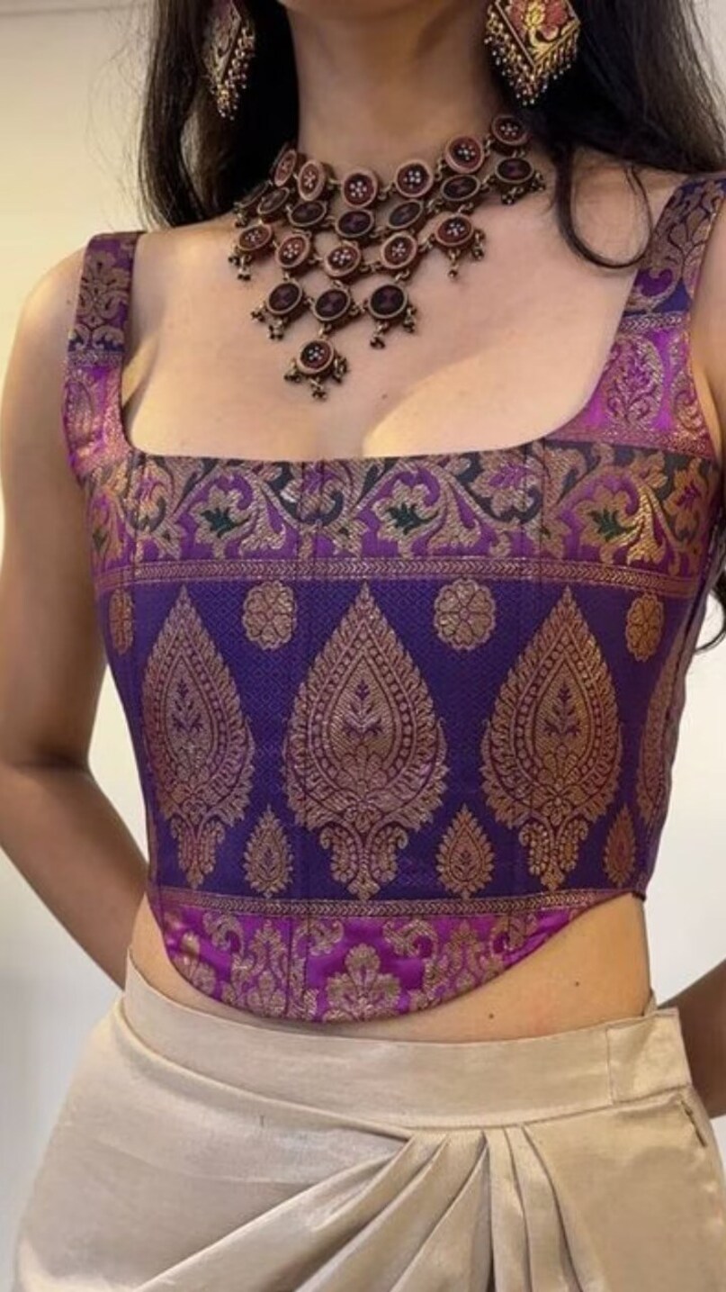 Corset Style Blouse: Fitted corset blouse is also a trendy style. This blouse with lehenga gives a bold and confident look and highlights your figure beautifully.