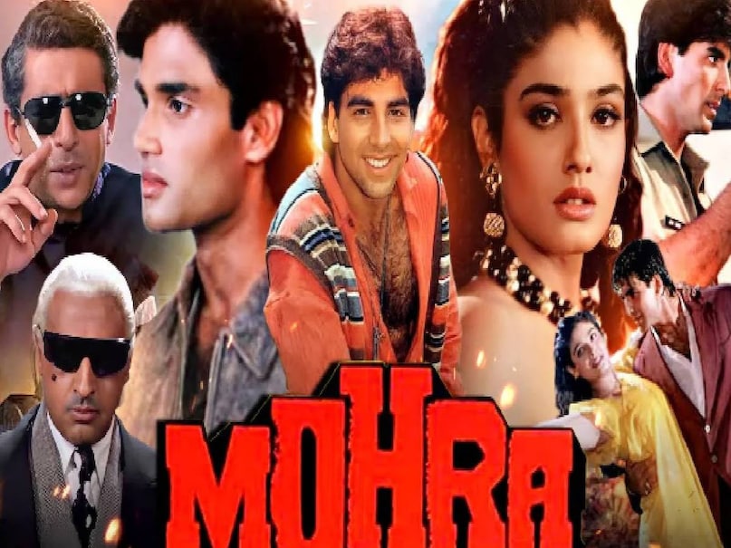 akshay kumar sunil shetty ka mohra film, akshay kumar mohra picture, Mohra movie akshay kumar, mohra movie suniel shetty ki, mohra film tu cheez badi hai song, Mohra Movie Unknown Facts, Mohra Movie budget, Mohra Movie box office collection, Mohra Movie cast, Mohra hit or flop, What was special about the Mohra film,  Mohra movie director, Mohra movie Raveena Tandon, Na Kajre Ki Dhar mohra moive, Tu Cheez Badi Hai Mast Mast movie song, mohra movie villain name list, Mohra Jibran villain, media tycoon Mr Jindal mohra movie,  Na Kajre Ki Dhar song muksh kumar, Mohra movie verdict