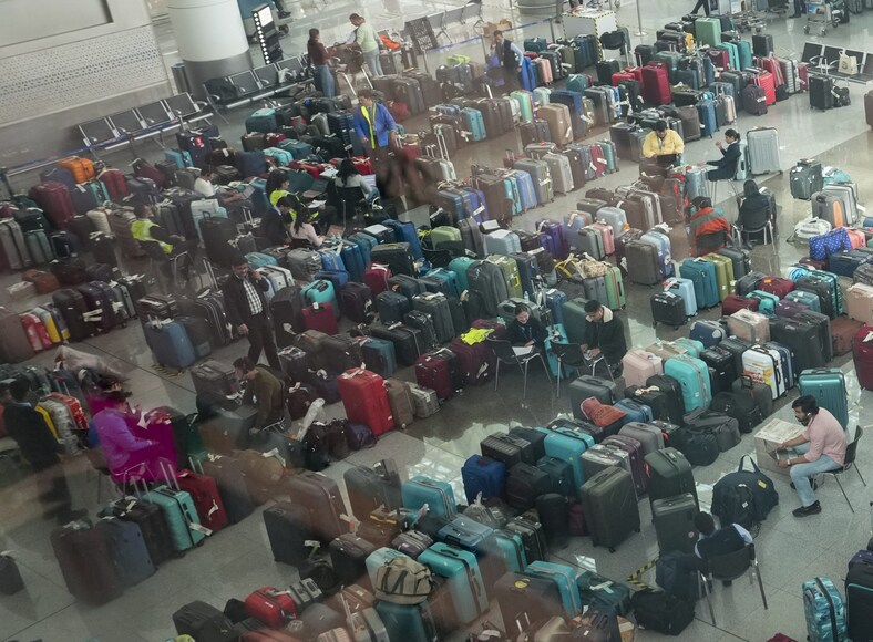New Delhi: Luggage of passengers piled up at the Indira Gandhi International Airport amid IndiGo flight disruptions, in New Delhi, Monday, Dec. 8, 2025. (PTI Photo/Arun Sharma) (PTI12_08_2025_000222B)