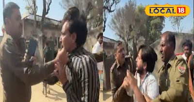 युवक की कॉलर पकड़कर बीच सड़क पर गिराते पुलिसकर्मी 