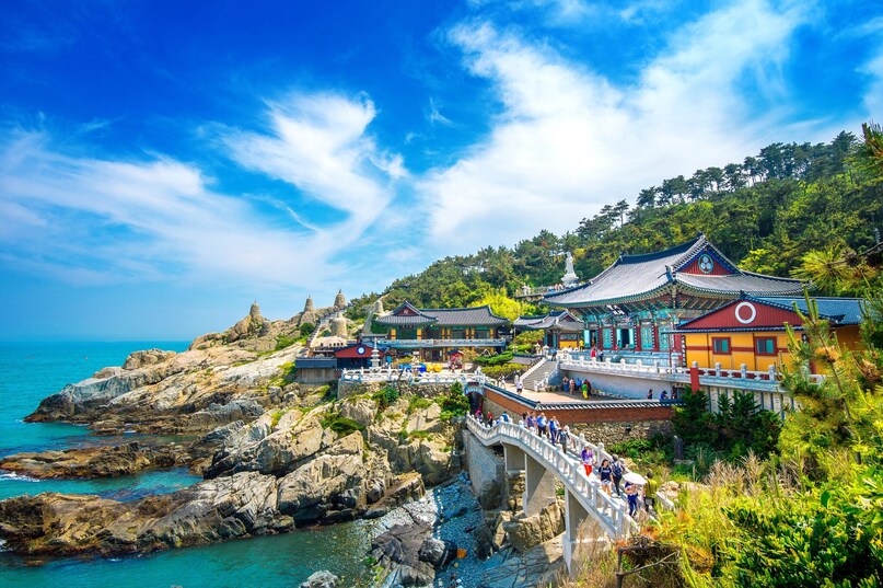 Busan: South Korea’s second-largest city, offers a striking contrast to Seoul. This bustling port city exudes a rougher, coastal energy while boasting dramatic natural beauty. Haeundae Beach, one of Korea’s most famous stretches of sand, curves gently along the shore, backed by a skyline of high-rise hotels. Busan: South Korea’s second-largest city, offers a striking contrast to Seoul. This bustling port city exudes a rougher, coastal energy while boasting dramatic natural beauty. Haeundae Beach, one of Korea’s most famous stretches of sand, curves gently along the shore, backed by a skyline of high-rise hotels.