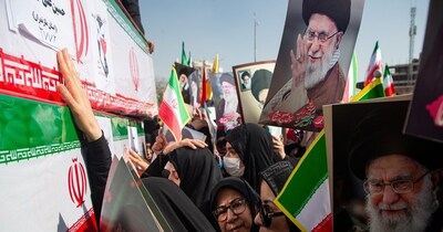 Some holding pictures of  the late Iranian Supreme Leader Ayatollah Ali Khamenei, mourners reach out to coffins during a funeral for people killed during the ongoing U.S.–Israeli military campaign in Isfahan, Iran, Thursday, March 5, 2026. (Payman Shahsanaei/ISNA via AP)