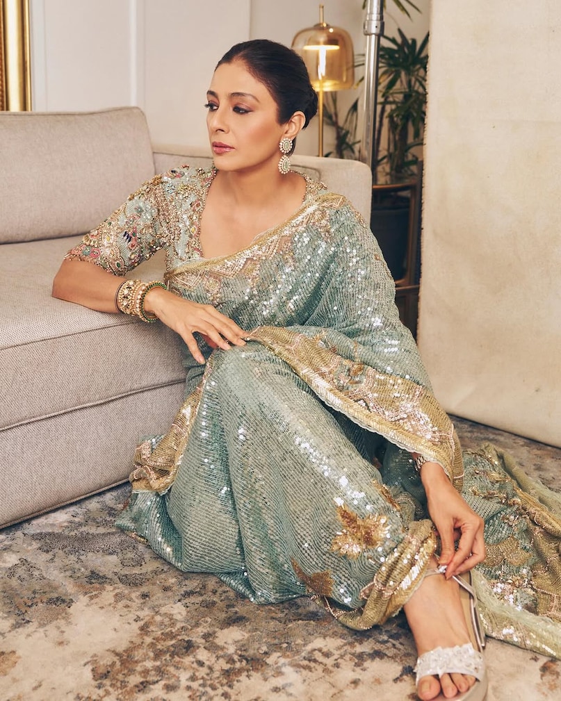 Tabu frosted blue saree look, तबु फ्रॉस्टेड ब्लू साड़ी लुक, Tabu sequin tulle saree, तबु सीक्विन ट्यूल साड़ी, Art deco saree design, आर्ट डेको साड़ी डिजाइन, Birds of Paradise saree, बर्ड्स ऑफ पैराडाइज साड़ी, tabu latest look,tabu saree look, how to style a frosted blue saree,tabu vintage royal look tips,birds of paradise motif saree, art-deco pattern saree design,edwardian lace blouse ideas,modern saree draping for weddings,best saree for summer events 2026,celebrity fashion tips