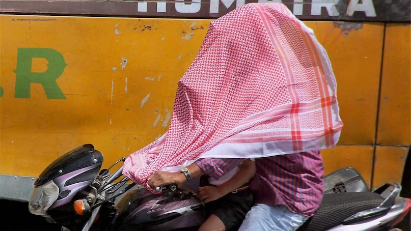 Allahabad: People cover their faces to protect themselves from scorching heat in Allahabad on Tuesday. (PTI Photo by Amar Deep) (PTI4_27_2017_000038B)