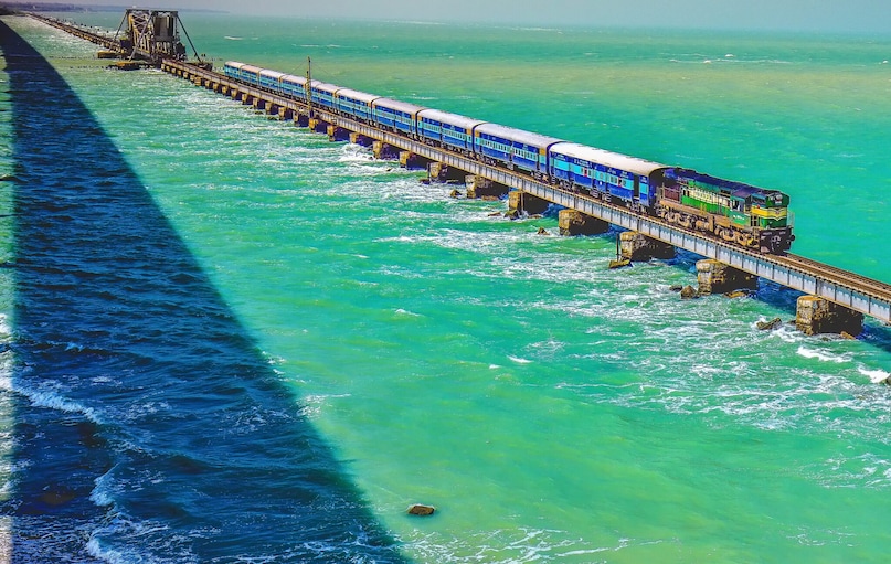 Chennai to Rameswaram (Rameswaram Express)The highlight of this journey is crossing the iconic Pamban Rail Bridge over the Bay of Bengal, where the sea stretches endlessly on both sides. The route ends at the sacred island town of Rameswaram, making it one of India's most unique railway experiences. (Train operations now use the newer rail bridge replacing the historic crossing.)