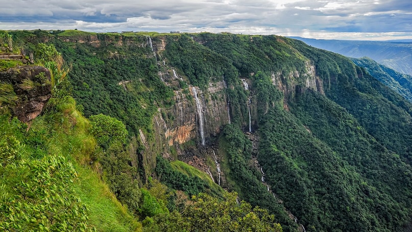 Cherrapunji, Meghalaya: The dramatic, deep gorges and towering waterfalls cutting through cloud-veiled plateaus give Cherrapunji a raw, powerful beauty similar to the Faroese or Icelandic landscapes. The intense rainfall creates an epic, windswept vista of green cliffs and rushing water. Cherrapunji, Meghalaya: The dramatic, deep gorges and towering waterfalls cutting through cloud-veiled plateaus give Cherrapunji a raw, powerful beauty similar to the Faroese or Icelandic landscapes. The intense rainfall creates an epic, windswept vista of green cliffs and rushing water.