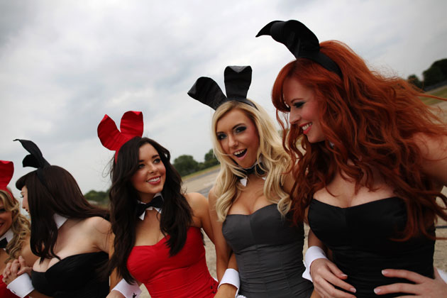 Playboy Bunnies wait airside for the arrival of Playboy founder Hugh Hefner at Stansted A...