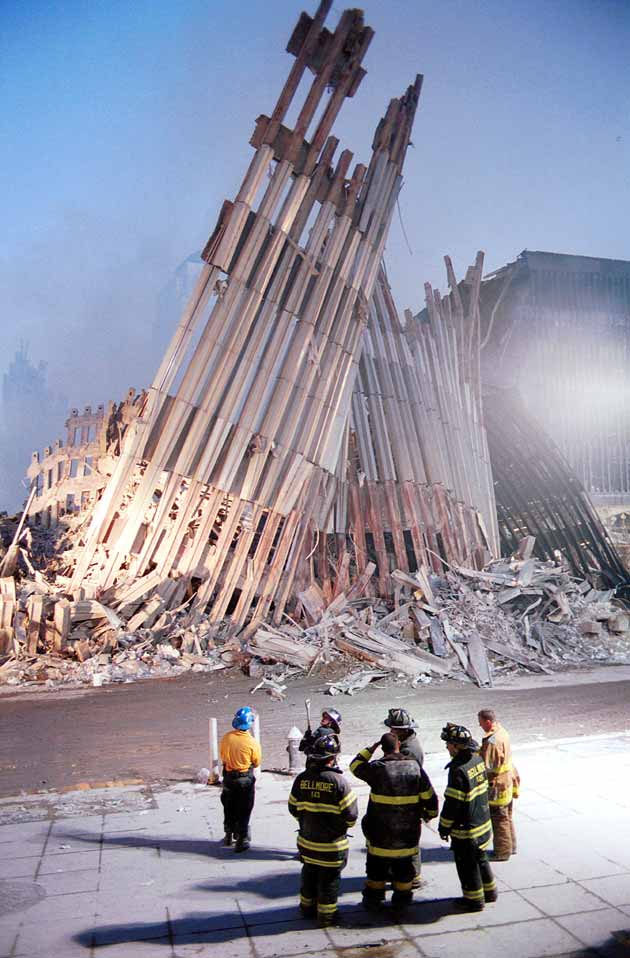 New York City firefighters look at the detroyed facade of the World Trade Center September 13, 2001 two days after the twin towers were destroyed when hit by two hijacked passenger jets.