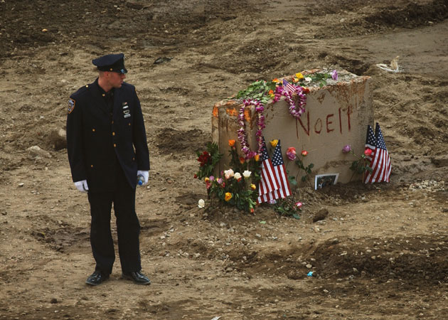 A policeman pauses at Ground Zero during the World Trade Center memorial September 11, 2002 in New York City. Mourners will attend memorial services throughout the day at Ground Zero for the one year anniversary of the World Trade Center terrorist attacks.