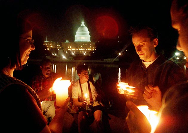 People hold candles on the US Capitol grounds during a vigil to remember victims who lost there lives in the recent terrorist attacks September 12, 2001 in Washington DC.