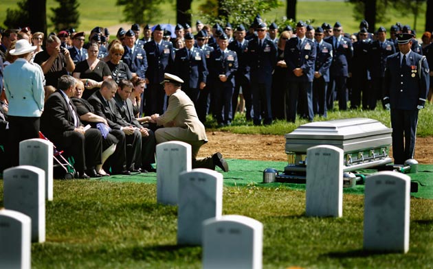 Chairman of the Joint Chiefs of Staff Admiral Mike Mullen pays his respect to the family of US Air Force Captain David Anthony Wisniewski during his burial service at Arlington National Cemetery August 23, 2010 in Arlington, Virginia. Originally from Moville, Iowa, the Air Force captain, 31, was the pilot of a Black Hawk helicopter that was shot down during a rescue mission in Afghanistan on June 9 and died of his injuries on July 2. Wisniewski is credited with saving more than 240 soldiers in seven tours of duty in Iraq and Afghanistan, 40 of which were saved in his final rescue mission in June. He was awarded the Purple Heart on June 23.