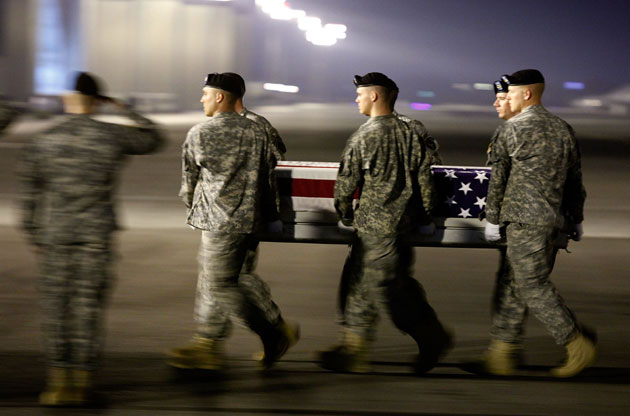 Members of a US Army carry team move the transfer case of US Army Sergeant Aaron M Smith during a dignified transfer at Dover Air Force Base on October 3, 2009 in Dover, Delaware. Sergeant Aaron M Smith who was from Manhattan, Kansas was killed in Afghanistan while supporting Operation Enduring Freedom. 