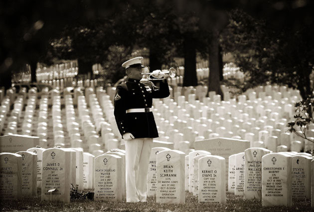 A US Marine Honor Guard bugler plays taps during an interment funeral ceremony for US Marine Cpl Mark David Kidd, of Milford, Michigan, at Arlington National Cemetery August 14, 2007 in Arlington, Virginia. Kidd who was killed at a checkpoint in the Al Anbar province of Iraq last January, was buried at Arlington after being interred and then exhumed in his home state of Michigan.