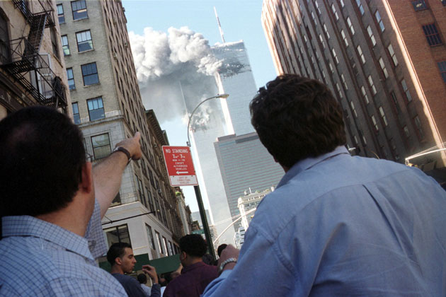 Pedestrians react to the World Trade Center collapse September 11, 2001. Two commercial airplanes crashed into the World Trade Center earlier.