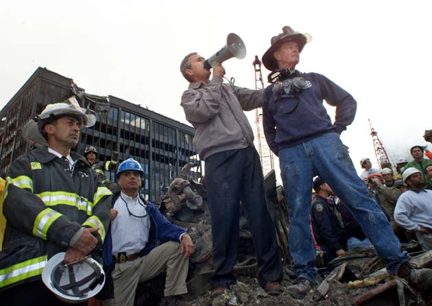 Two years and two wars after the September 11 attacks, President Bush's aura of invincibility has faded and his challenge may be to keep his presidency from being more associated with Americans dying in Iraq than with his dramatic pledge at Ground Zero to battle terrorism. Bush is shown with retired firefighter Bob Beckwith (R) at the scene of the World Trade Center disaster on September 14, 2001.