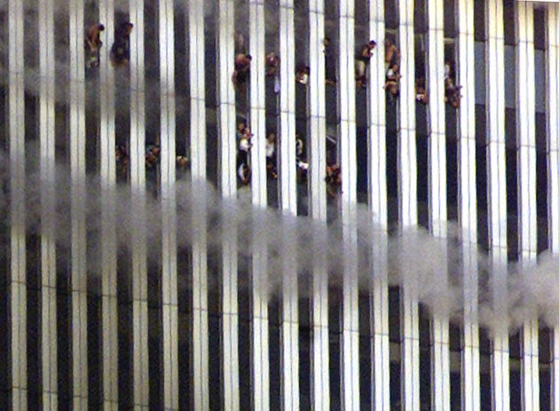 People look out of the burning North tower of the World Trade Center in New York City September 11, 2001. Both towers were hit by planes crashing into the buildings. Shortly after this photo was taken this tower fell. In the worst attack on American soil since Pearl Harbor, three hijacked planes slammed into the Pentagon and New York's landmark World Trade Center on Tuesday, demolishing the two 110-story towers that symbolise US financial might.