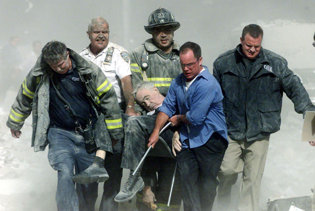 A September 11, 2001 file photo of rescue workers carry mortally injured New York City Fire Department chaplain. A September 11, 2001 file photo shows rescue workers carrying mortally injured New York City Fire Department chaplain, the Rev. Mychal Judge, from the wreckage of the World Trade Center in New York City. The Chaplain was crushed to death by falling debris while giving a man last rites in the trade center. New York City plans to mark the third anniversary of the attacks on the trade center with an observance at the site on September 11 with parents and grandparents of victims reading their names.