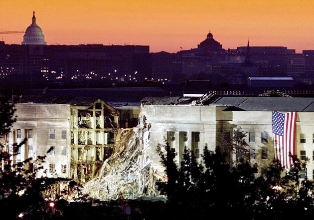 The damaged area of the Pentagon building, where a commercial jetliner slammed into it September 11, is seen in the early morning at sunrise with the US Capitol Building in the background, September 16, 2001. Both the Pentagon and the World Trade Center buildings in New York City were attacked Tuesday by hijacked commercial airliners.