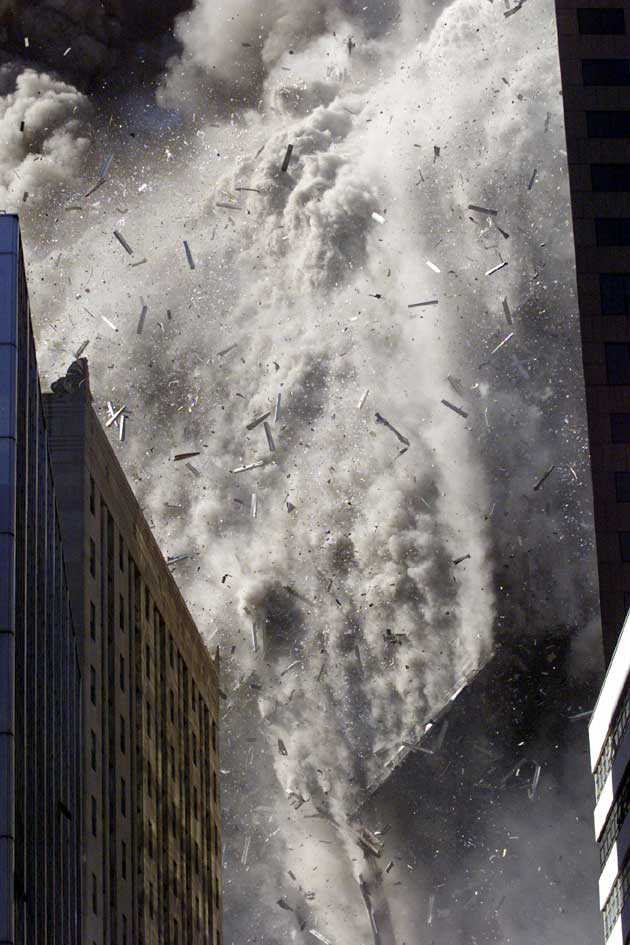 Smoke and debris fill the air after one of the World Trade Center towers in New York City collapsed in this file photo from September 11, 2001. This year's anniversary of the September 11 attacks in New York and Washington will echo the first one, with silence for the moments the planes struck and when the buildings fell, and the reading of 2,792 victims' names.