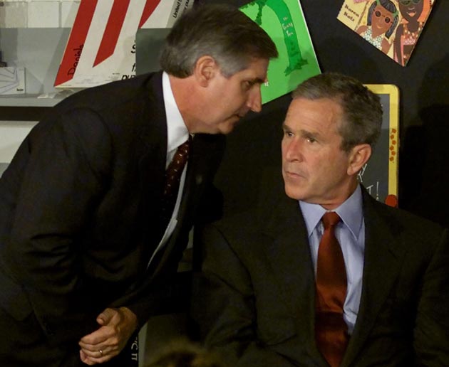 US President George W Bush listens as White House Chief of Staff Andrew Card informs him of a second plane hitting the World Trade Center while Bush was conducting a reading seminar at the Emma E Booker Elementary School in Sarasota, Florida, in this September 11, 2001 file photo. This year's anniversary of the September 11 attacks in New York and Washington will echo the first one, with silence for the moments the planes struck and when the buildings fell, and the reading of 2,792 victims' names.