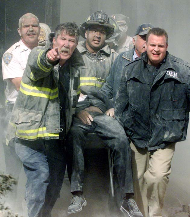 Rescue workers remove a man from the World Trade Center tower in New York City early September 11, 2001. Both towers were hit by planes crashing into the buildings. Victims from the attack on the World Trade Center, many suffering from extensive burns, began arriving at hospitals in New York City about an hour after two planes slammed into the twin towers.