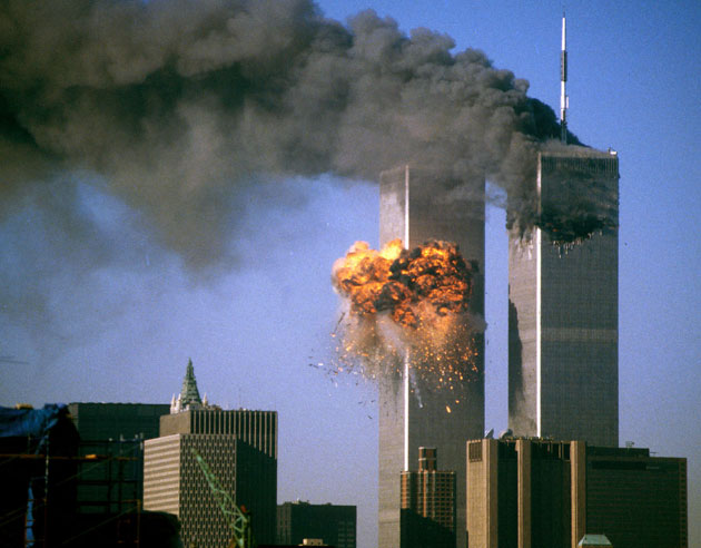The World Trade Center south tower (L) burst into flames after being struck by hijacked United Airlines Flight 175 as the north tower burns following an earlier attack by a hijacked airliner in New York, September 11, 2001.