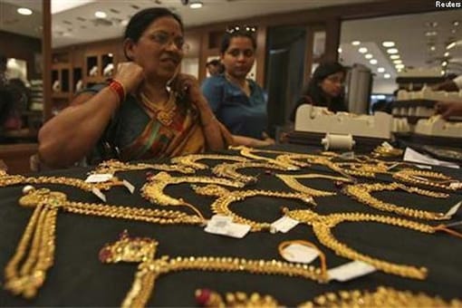 Gold prices drop to near three-year low on US data