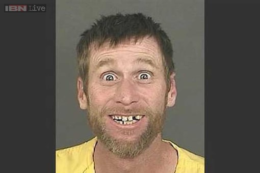 The happiest mugshot ever: Robber flashes a broad, toothy grin while posing for a mugshot in Denver