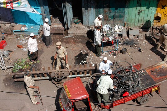 Local residents and police officers clear debris at a blast site in Malegaon on September 30, 2008. (Photo: Reuters) Local residents and police officers clear debris at a blast site in Malegaon on September 30, 2008. (Photo: Reuters)