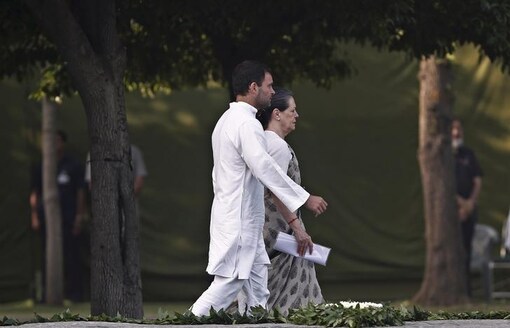 Congress party chief Sonia Gandhi (R) walks along with her son and MP Rahul Gandhi. (Picture Courtesy: Reuters)