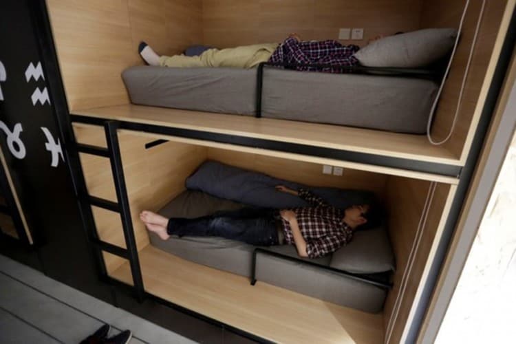 The Wider Image: Working, eating and sleeping at the office