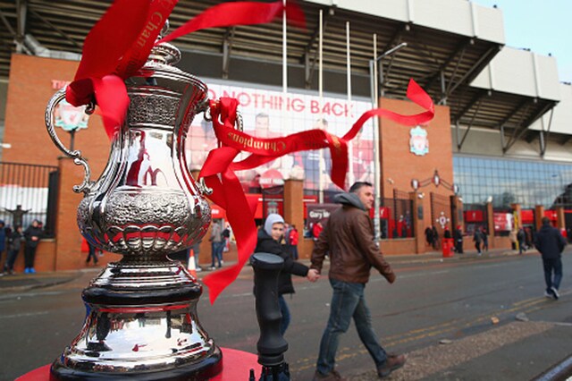 File photo to FA Cup trophy resting outside Anfield as fans walk by (Getty Images)
