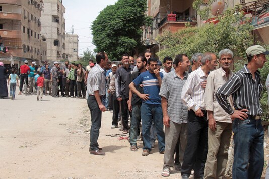 Palestinians refugees wait in line to receive parcels of humanitarian aid from the United Nations Relief and Works Organization. (File picture) Palestinians refugees wait in line to receive parcels of humanitarian aid from the United Nations Relief and Works Organization. (File picture)