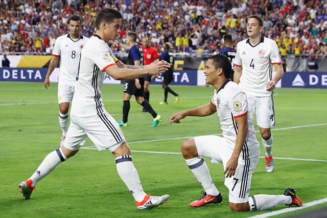 Colombia's Carlos Bacca celebrates with James Rodriguez after scoring against the United States. (Getty Images)