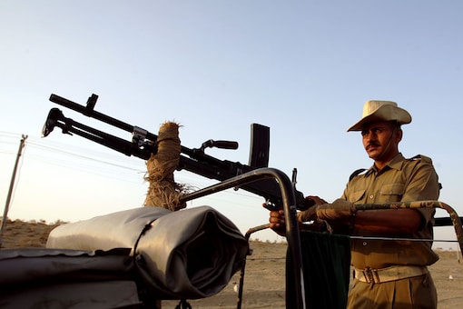 A Border Security Force personnel patrols near zero point between India and Pakistan in Munabao in Rajasthan. (Reuters)