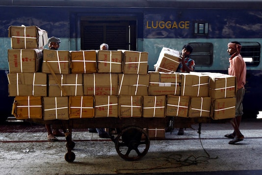 Porters prepare to load goods onto a train at a railway station. (File photo: Reuters) Porters prepare to load goods onto a train at a railway station. (File photo: Reuters)