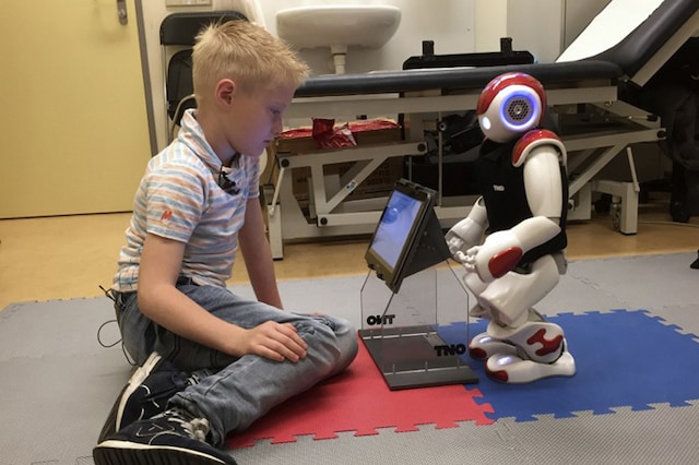Dutch boy Ruben van As, 7, plays with Charlie Robot, which is helping to teach him about managing his diabetes at the Gelderse Vallei hospital in Ede, the Netherlands, on June 28, 2016.  Image: Jo Biddle/ AFP