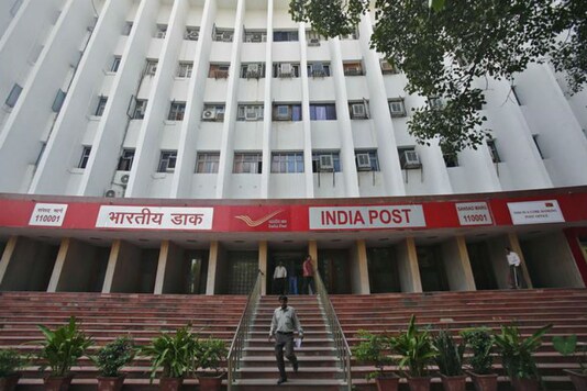 A man walks down the staircase of an Indian post office in New Delhi/File Photo.