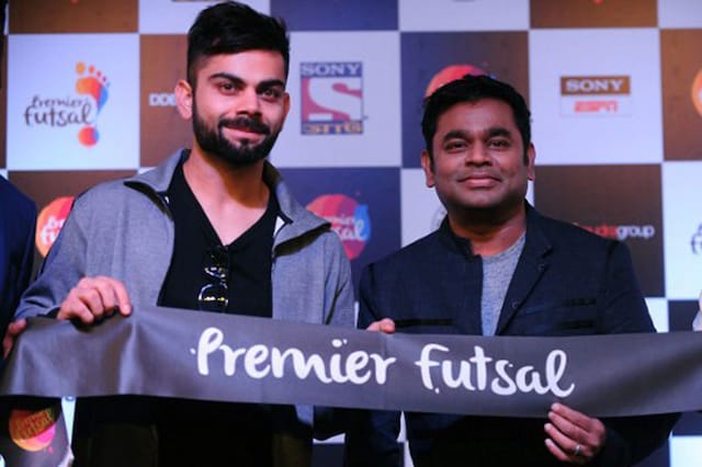 Virat Kohli (L) poses alongside Bollywood music director A.R.Rahman gestures during launch of 'Premier futsal'.   (Photo Credit: AFP)
