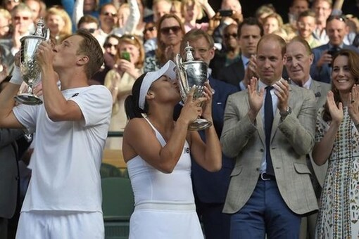 Great Britain's Heather Watson and Finland's Henri Kontinen celebrate winning the mixed doubles final with the trophies. (Reuters Image)