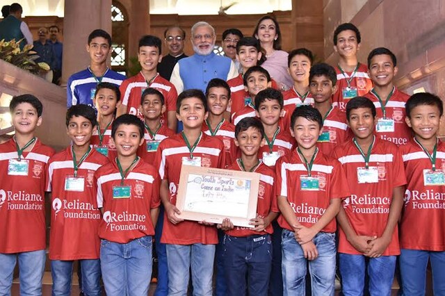PM Modi in group photo with the children, at the launch of Reliance Foundation Youth Sports, via video conferencing. (PIB India)